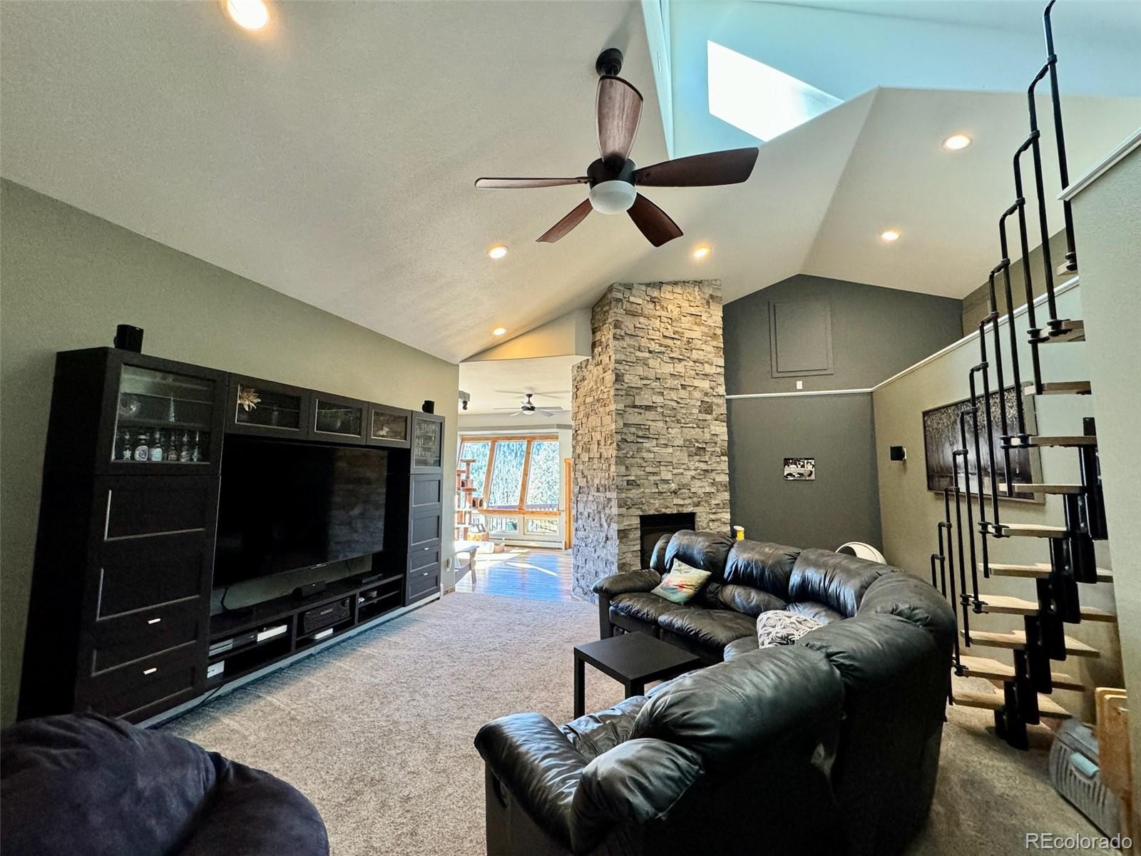 20670 Rangeview Drive Morrison, CO 80465 - Photo 20 of 39 a living room with furniture and a flat screen tv
