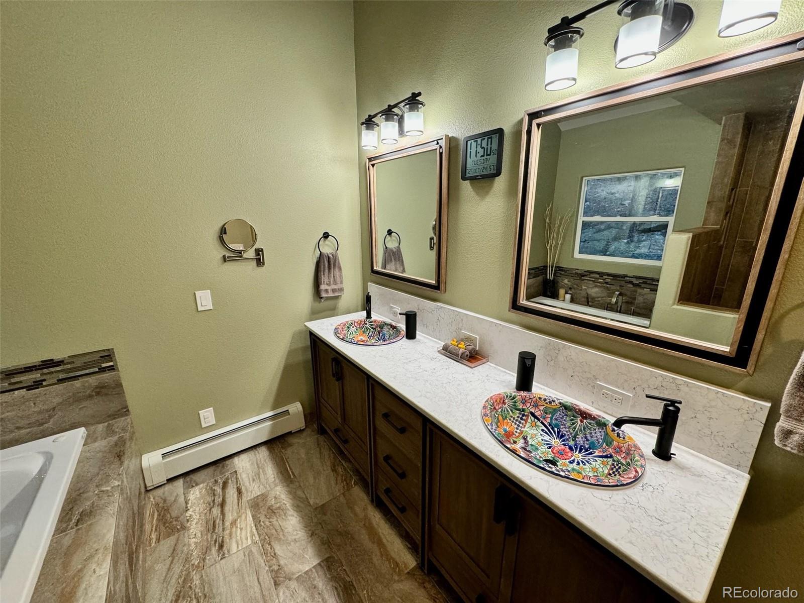 20670 Rangeview Drive Morrison, CO 80465 - Photo 24 of 39 a bathroom with a sink a toilet and mirror