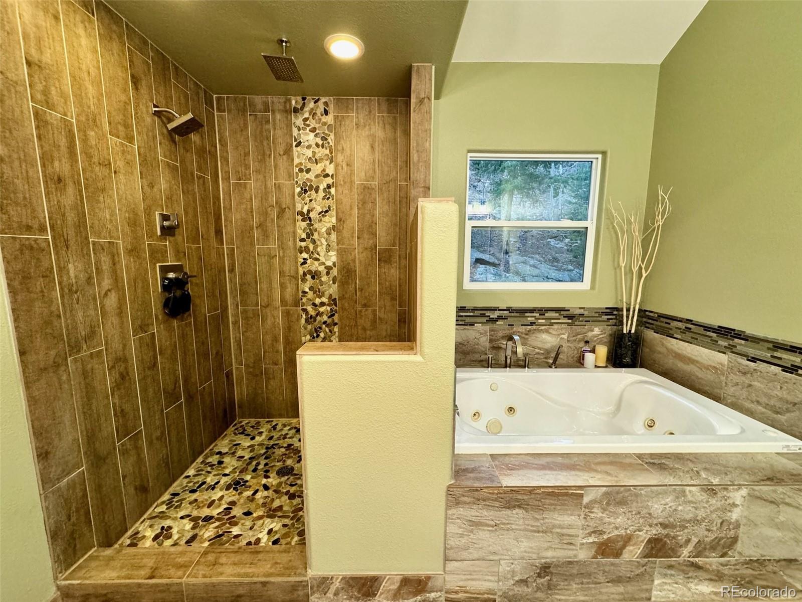 20670 Rangeview Drive Morrison, CO 80465 - Photo 25 of 39 a bathroom with a bathtub and shower