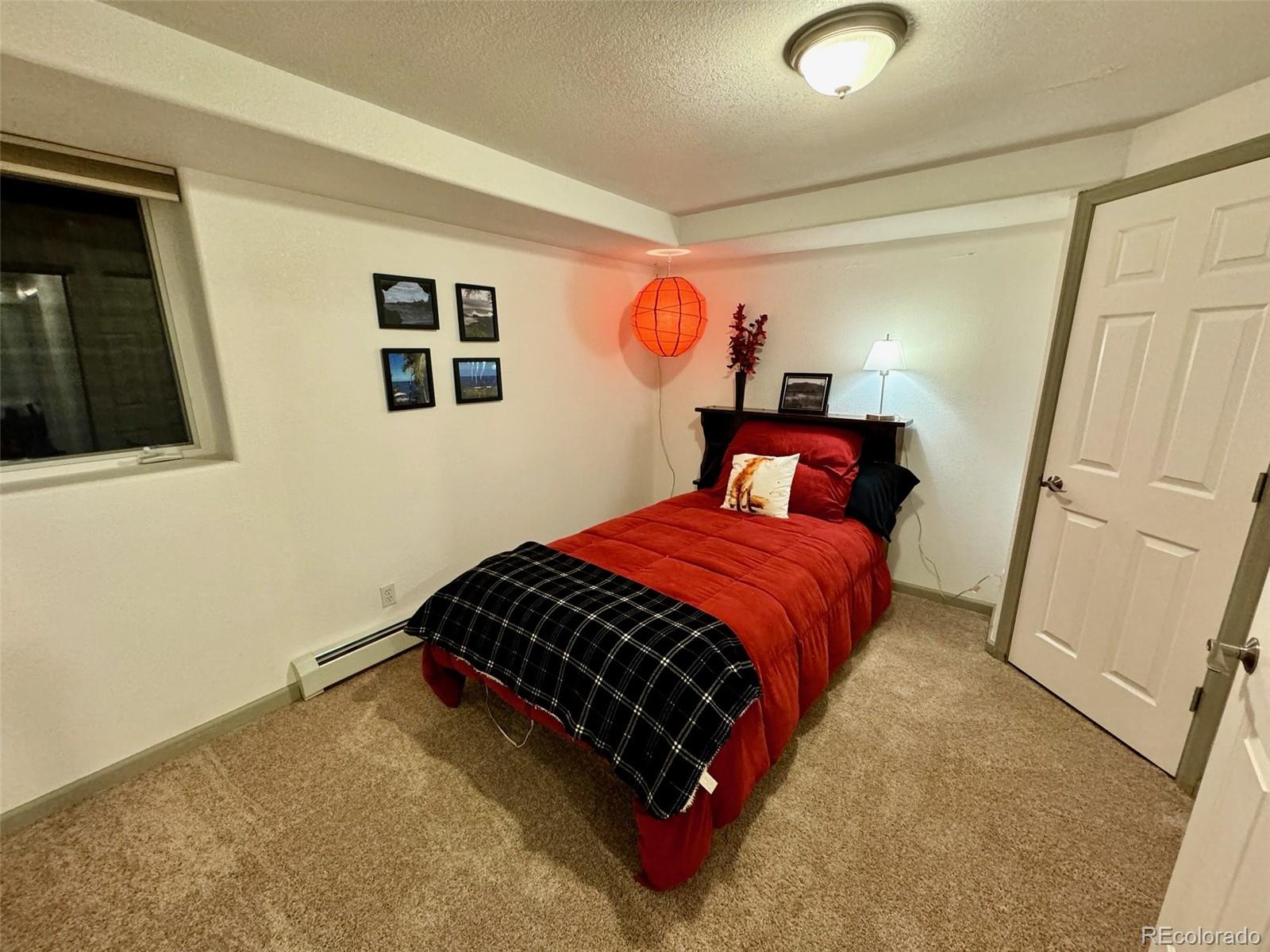20670 Rangeview Drive Morrison, CO 80465 - Photo 28 of 39 a bedroom with a bed and a window