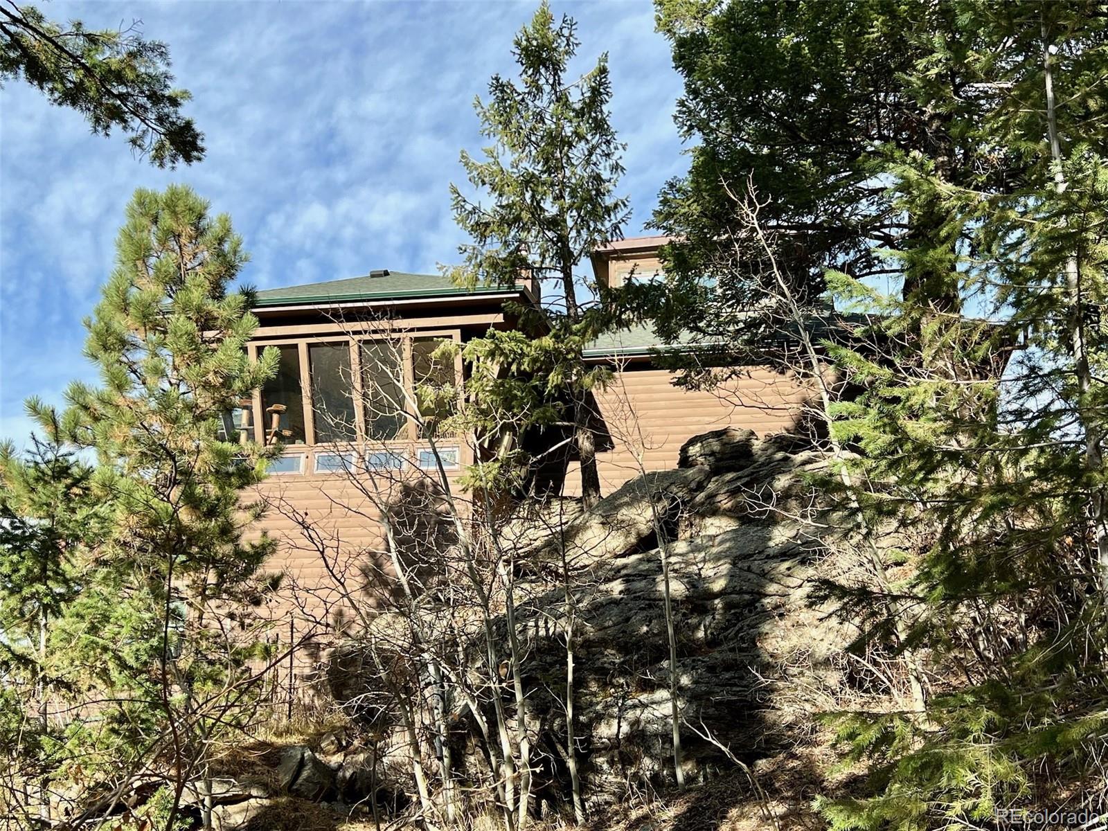 20670 Rangeview Drive Morrison, CO 80465 - Photo 6 of 39 a view of a house with a tree