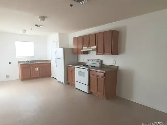 a kitchen with stainless steel appliances a refrigerator stove and sink