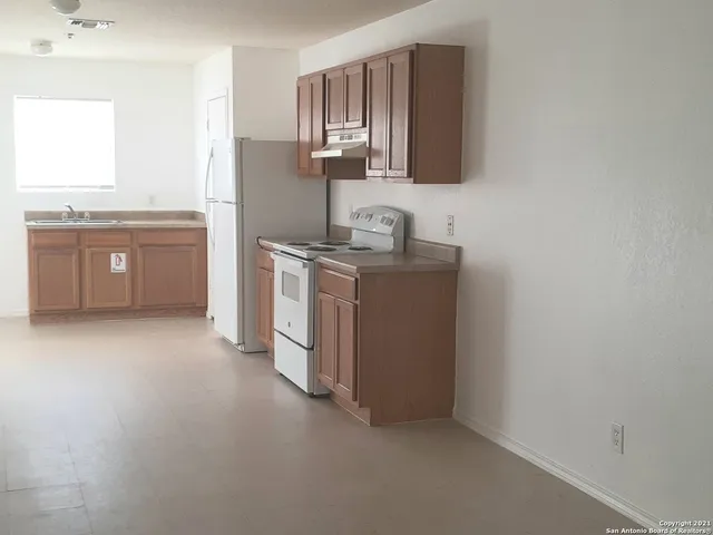a kitchen with stainless steel appliances granite countertop a sink and a stove top oven
