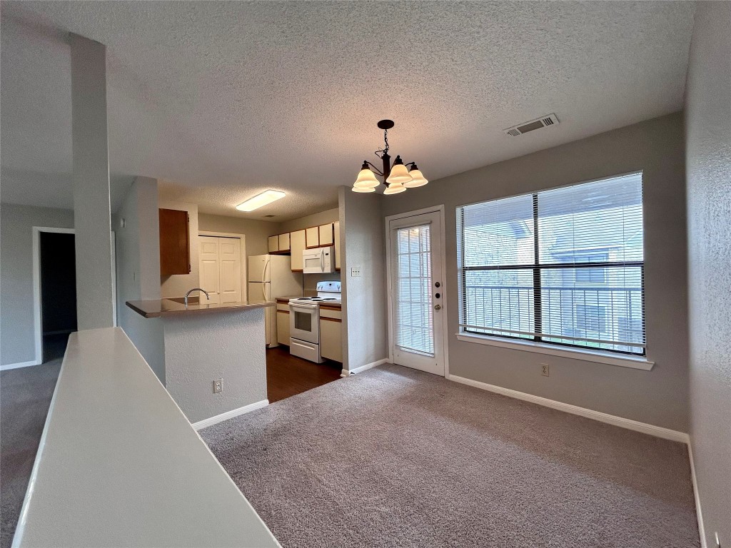 a view of a kitchen next to a window