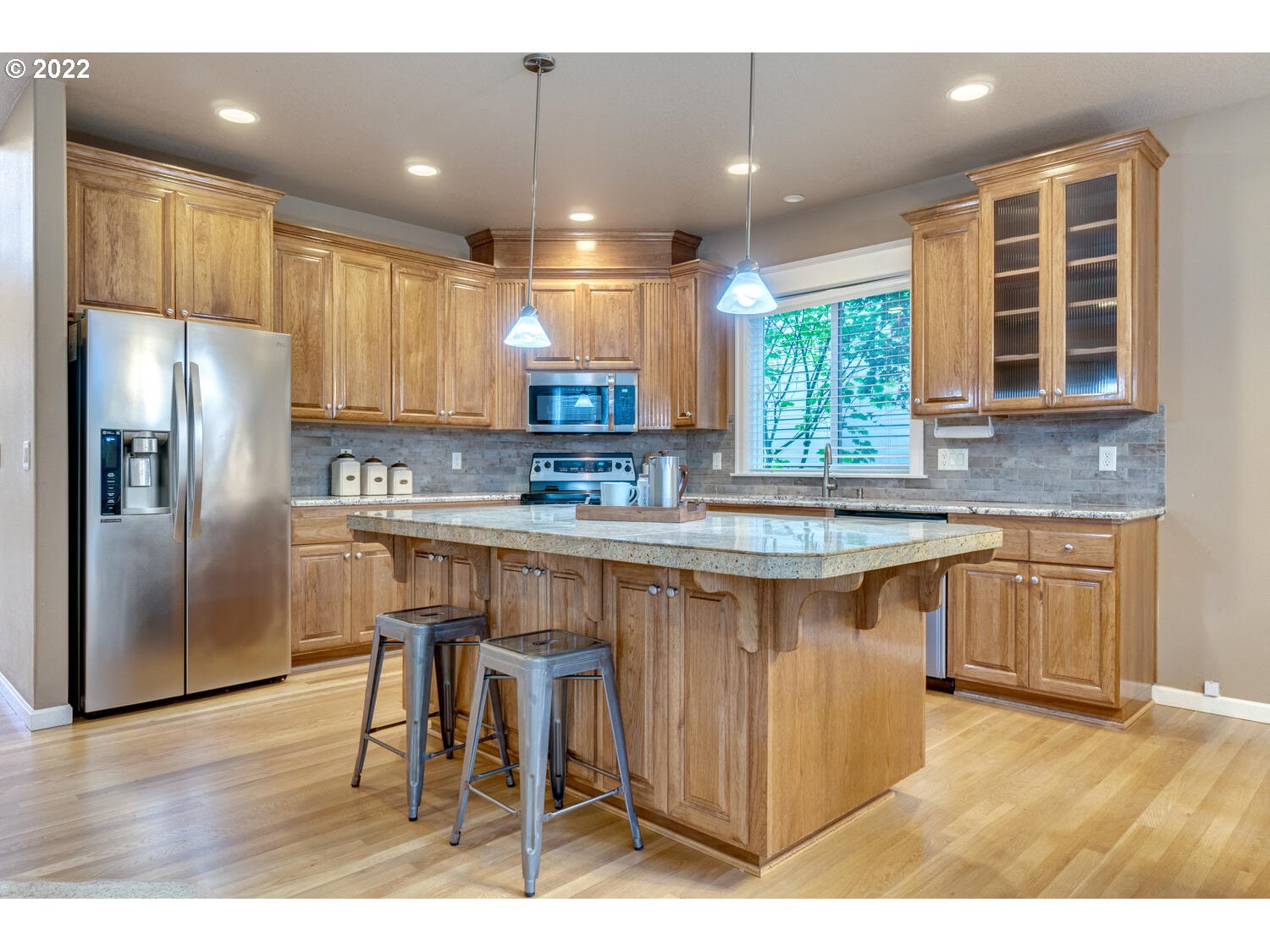 17496 Southwest 105th Avenue Tualatin, OR 97062 - Photo 13 of 28 a kitchen with kitchen island granite countertop a sink cabinets and stainless steel appliances