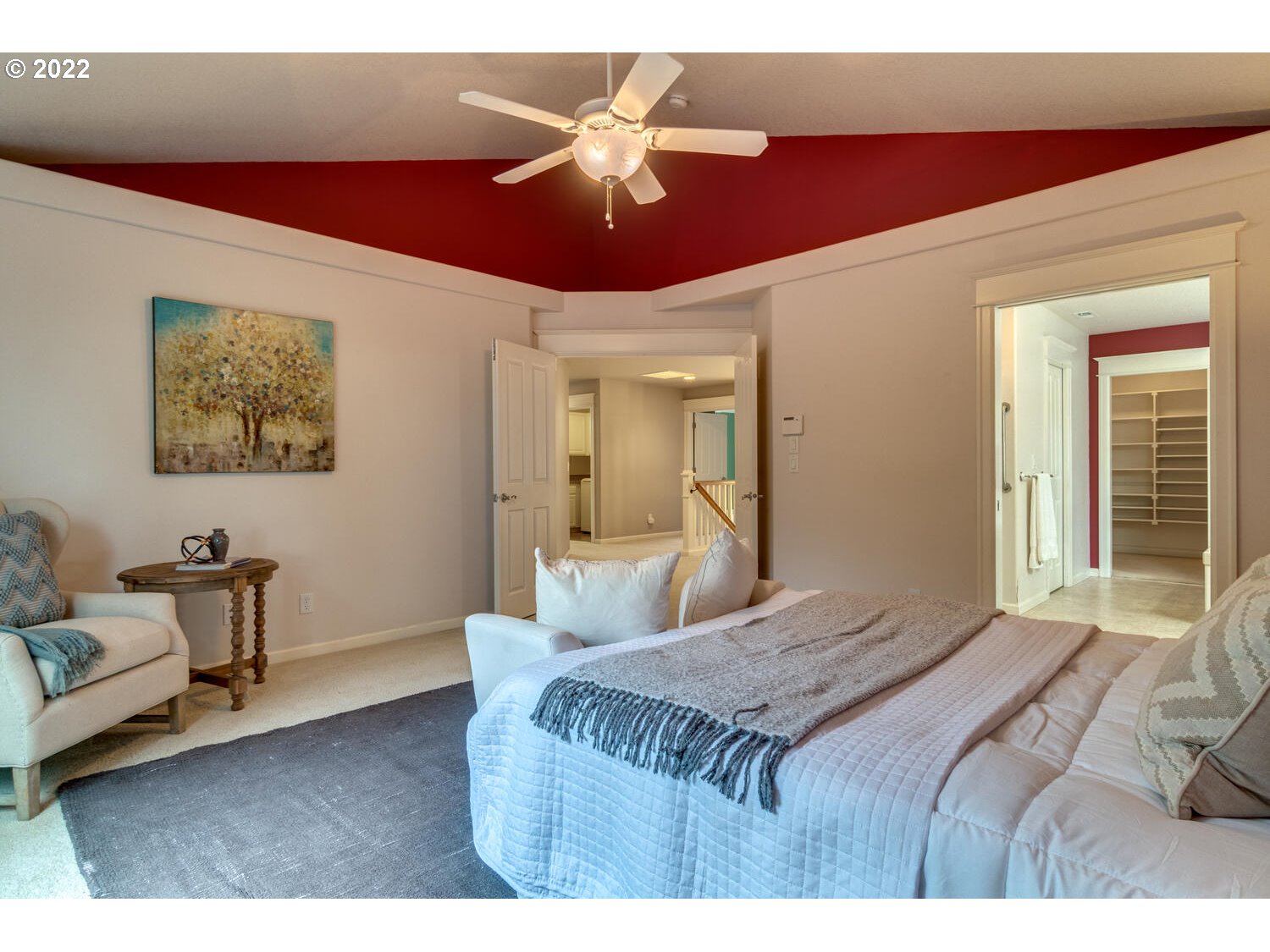 17496 Southwest 105th Avenue Tualatin, OR 97062 - Photo 18 of 28 a bedroom with a bed and a chandelier