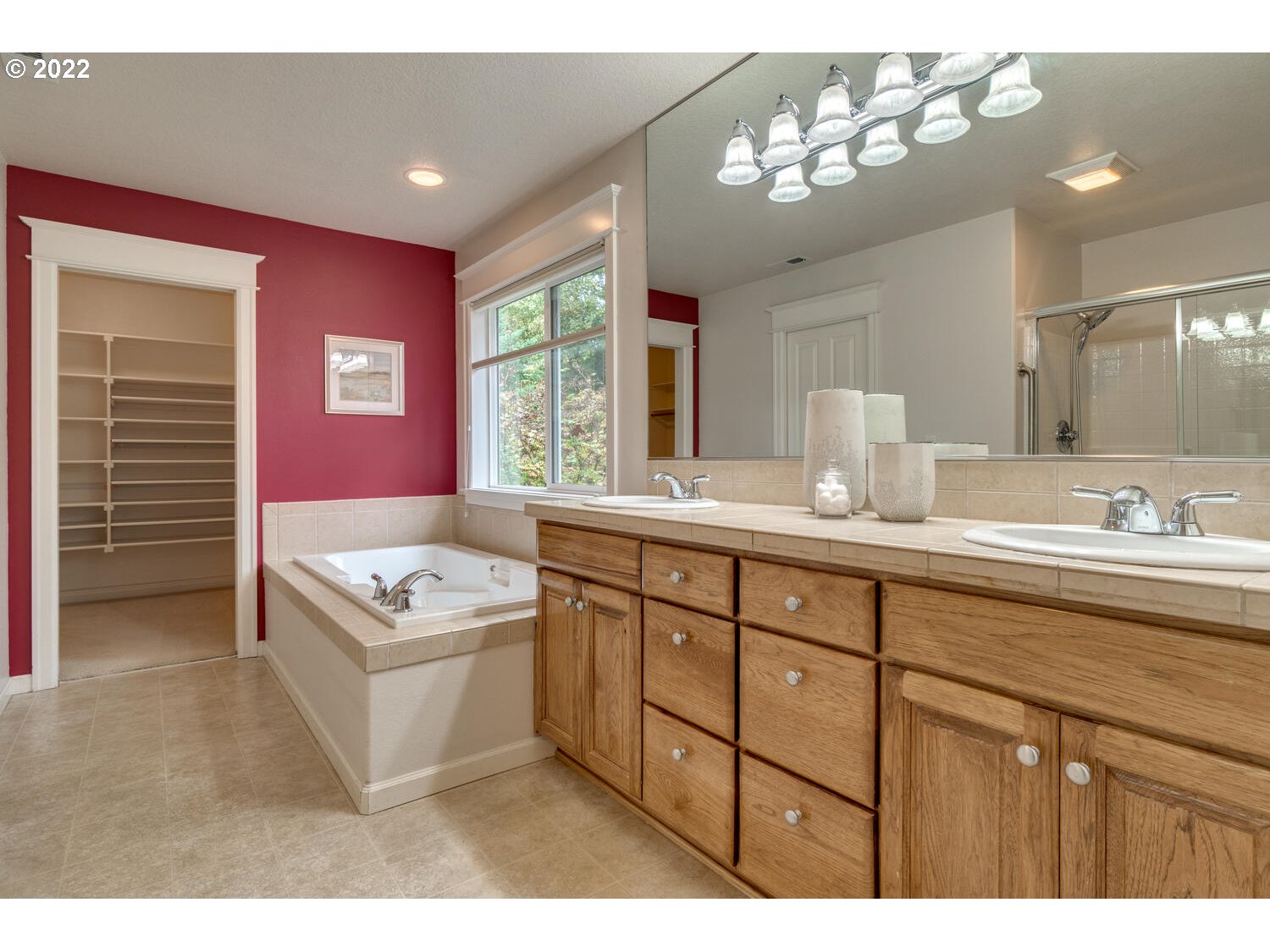 17496 Southwest 105th Avenue Tualatin, OR 97062 - Photo 19 of 28 a bathroom with a granite countertop sink a large mirror and a bathtub