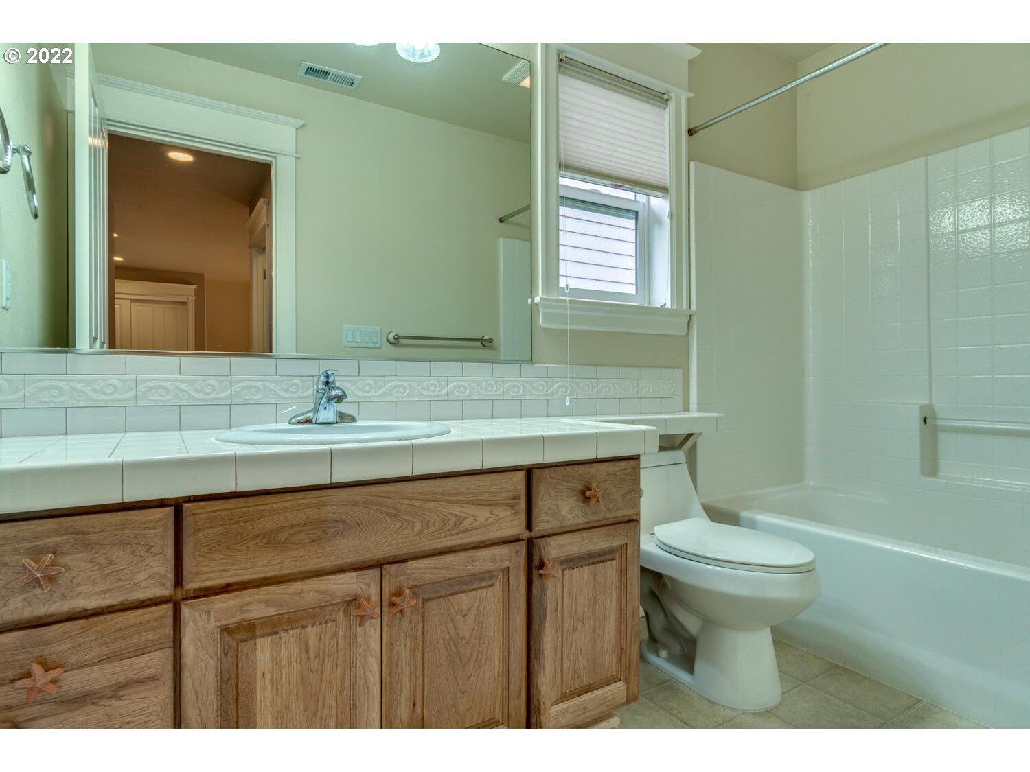 17496 Southwest 105th Avenue Tualatin, OR 97062 - Photo 23 of 28 a bathroom with a sink and a mirror
