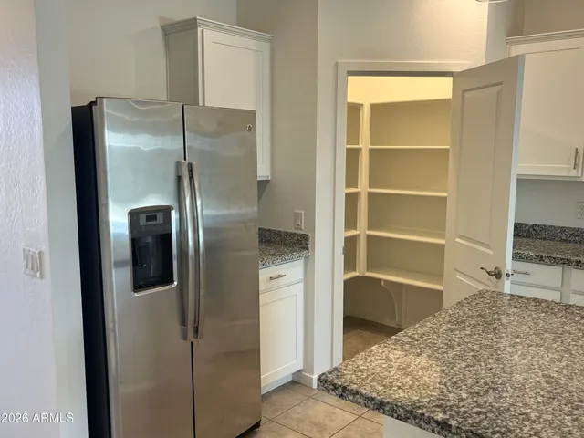 a view of a refrigerator in kitchen and wooden floor