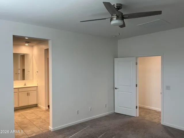 an empty room and chandelier fan in a room