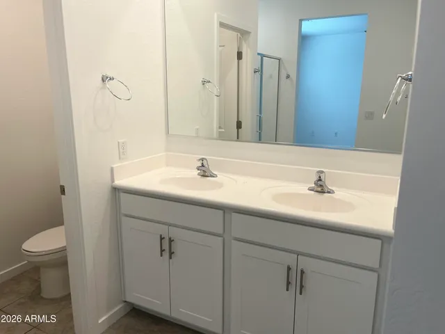 a bathroom with a sink toilet and a mirror
