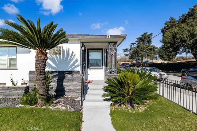 a house view with a seating space and garden