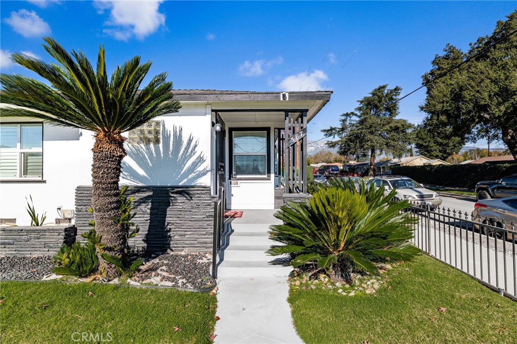 a house view with a seating space and garden