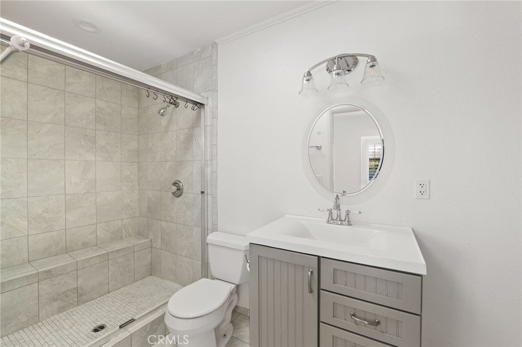 587 East Arrow Highway Upland, CA 91786 - Photo 13 of 17 a bathroom with a sink a toilet and shower
