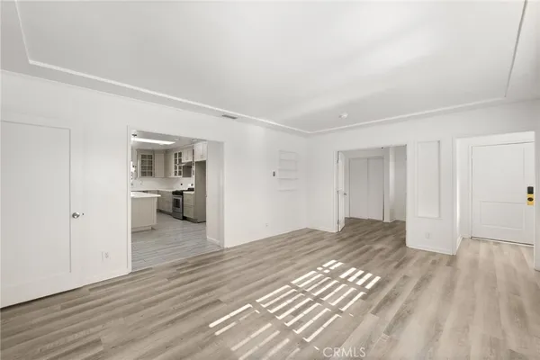 a big room with wooden floor and a bathroom