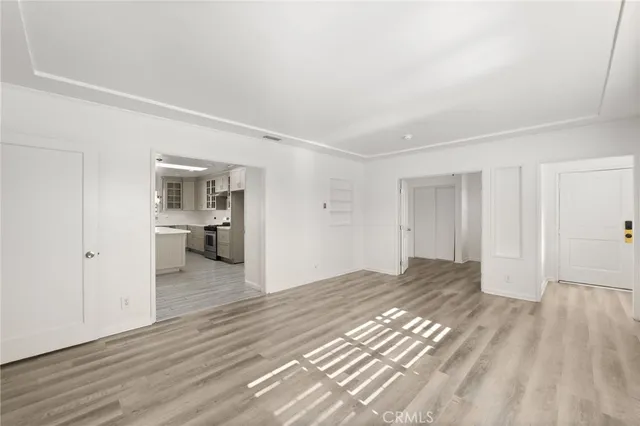 a big room with wooden floor and a bathroom