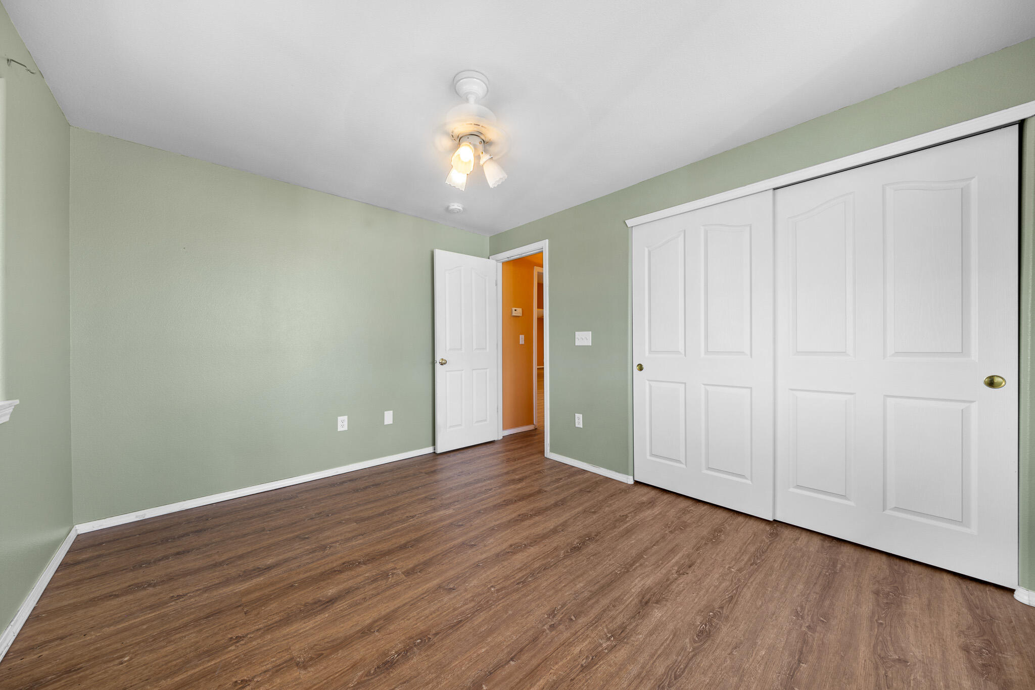 1549 Glacier Ridge Road Bend, OR 97701 - Photo 20 of 27 a view of an empty room with wooden floor