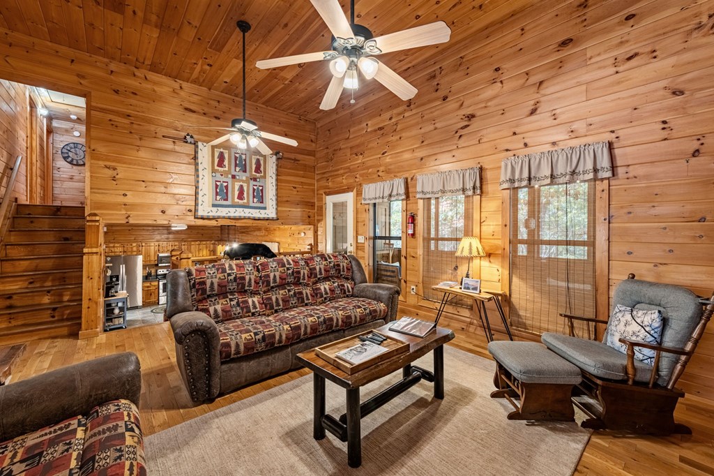 196 Ethan Wilson Way Morganton, GA 30560 - Photo 10 of 66 a living room with furniture ceiling fan and a rug
