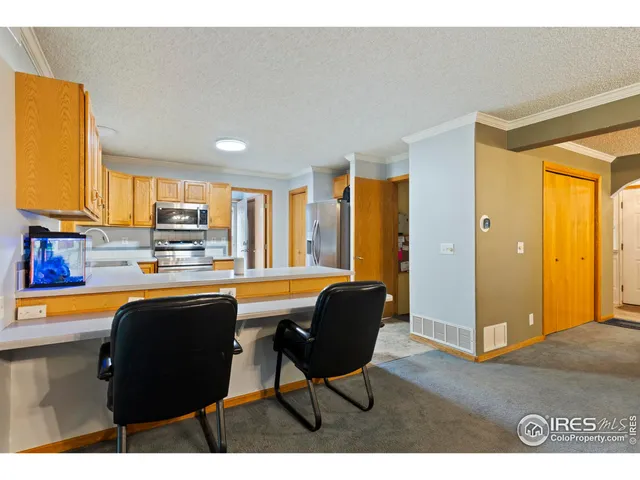 a kitchen with a table chairs and refrigerator