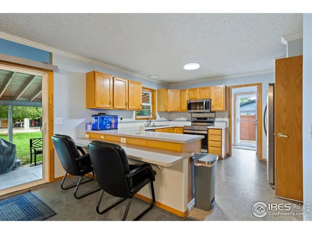 a kitchen with a table chairs refrigerator and cabinets