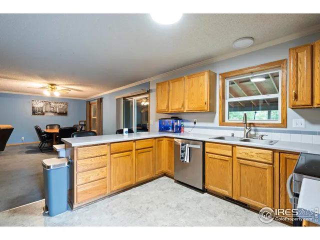 a kitchen with stainless steel appliances granite countertop a sink counter space and a large window