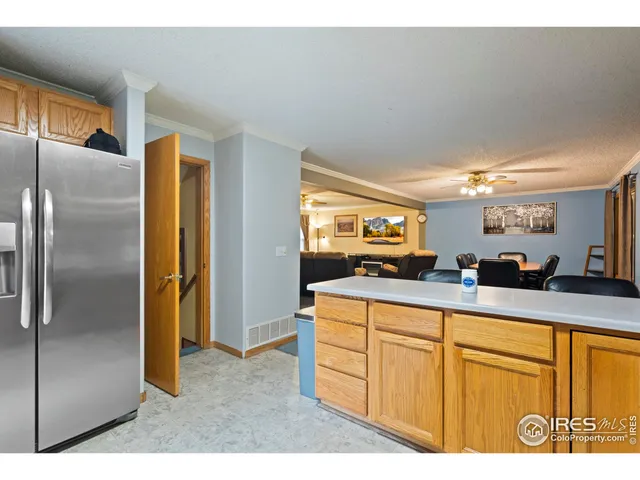 a kitchen view with stainless steel appliances a refrigerator and a sink