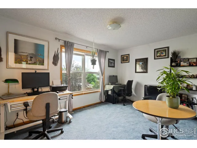 a work room with furniture and a potted plant