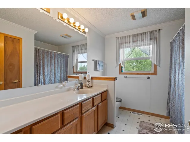 a kitchen with a sink cabinets and wooden floor