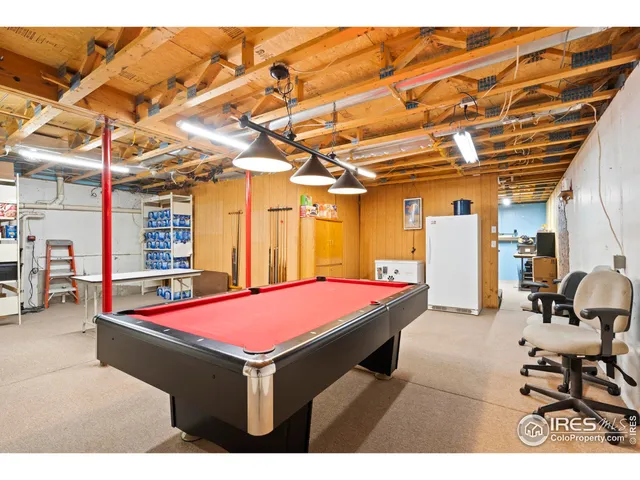 a room with pool table and furniture
