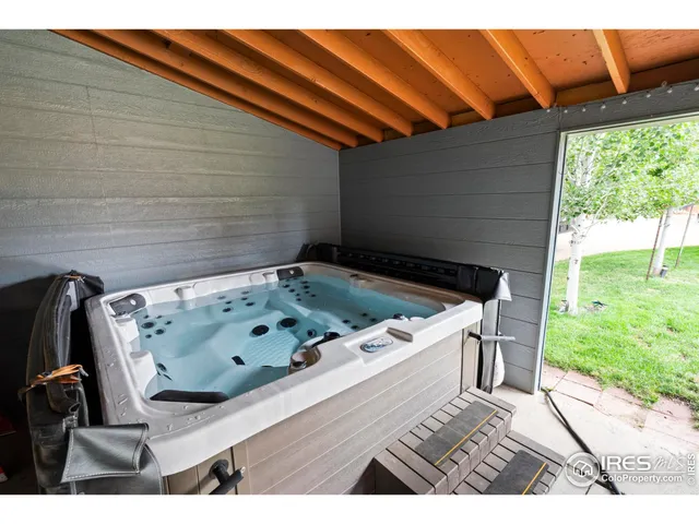 a view of a backyard with table and chairs and garden