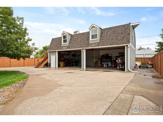 a view of house with outdoor space and parking