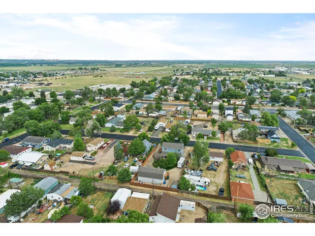 an aerial view of residential houses with city view