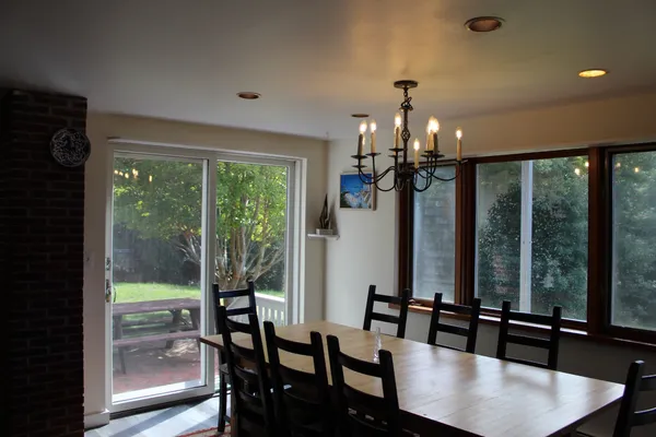 a view of a dining room with furniture window and wooden floor