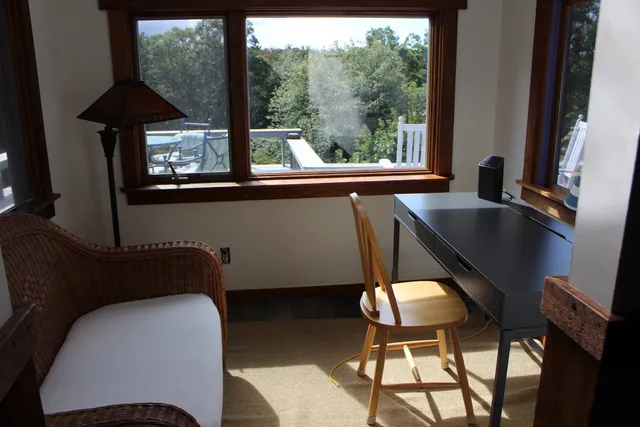 a view of hallway with wooden floor and furniture