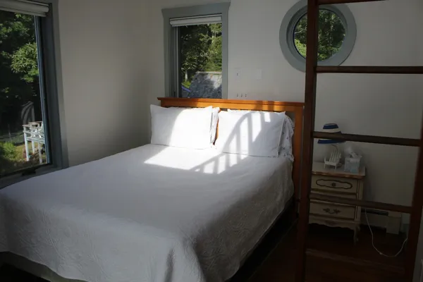 an aerial view of a house with swimming pool and sitting area