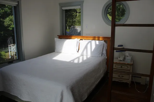an aerial view of a house with swimming pool and sitting area