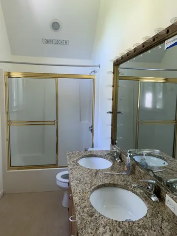 a view of a balcony with wooden floor and fence
