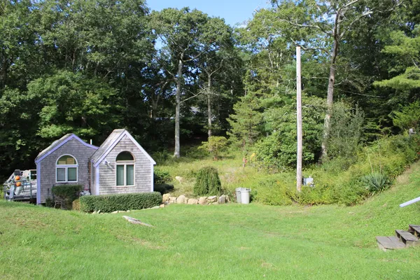 a view of a livingroom with a large window and wooden floor