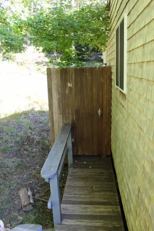 a bathroom with a granite countertop toilet sink and mirror