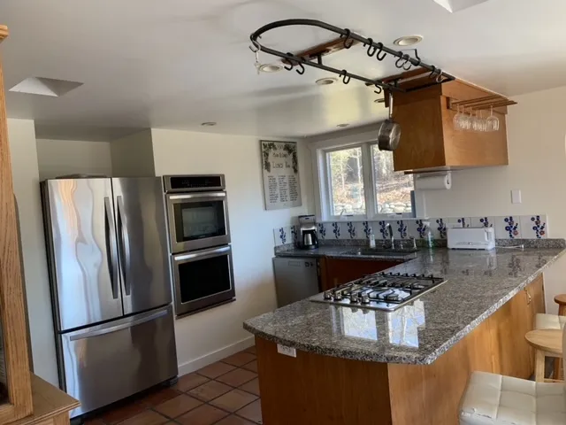 a stove top oven sitting inside of a kitchen