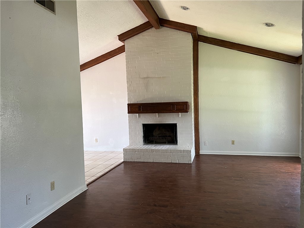 2203 Windsor Drive Bryan, TX 77802 - Photo 3 of 7 a view of an empty room with wooden floor and a fireplace