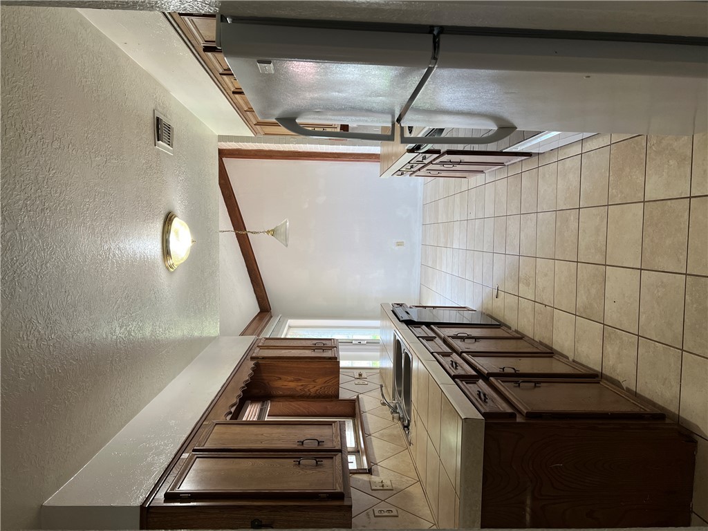 2203 Windsor Drive Bryan, TX 77802 - Photo 5 of 7 a kitchen with stainless steel appliances granite countertop a sink and a refrigerator