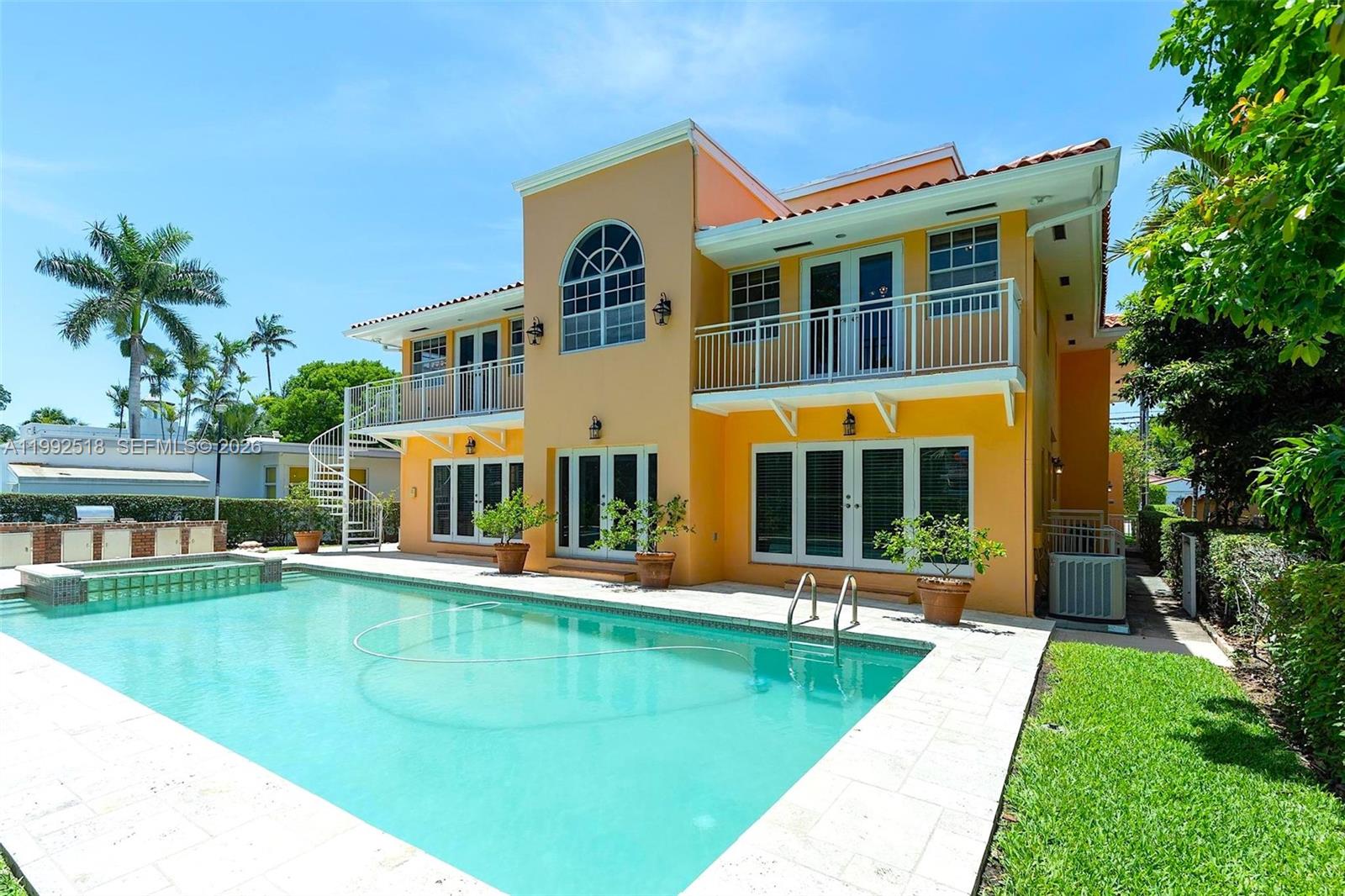 5309 Alton Road Miami Beach, FL 33140 - Photo 36 of 51 a front view of a house with a yard table and chairs