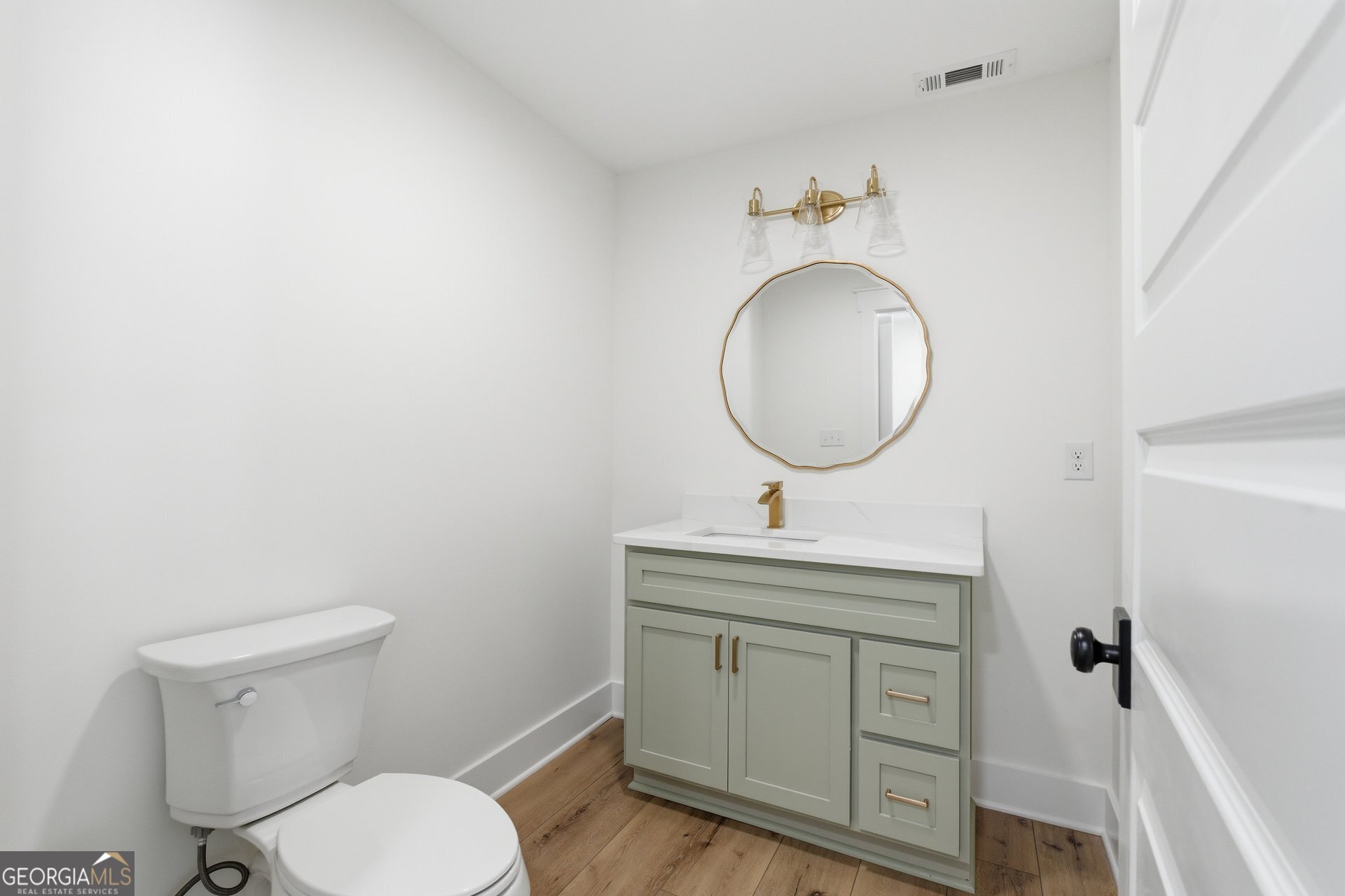 5938 Ridgeway Road Franklin, GA 30217 - Photo 15 of 41 a bathroom with a toilet a sink and mirror