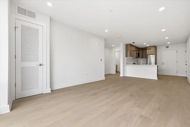 a view of a kitchen with a sink and white cabinets