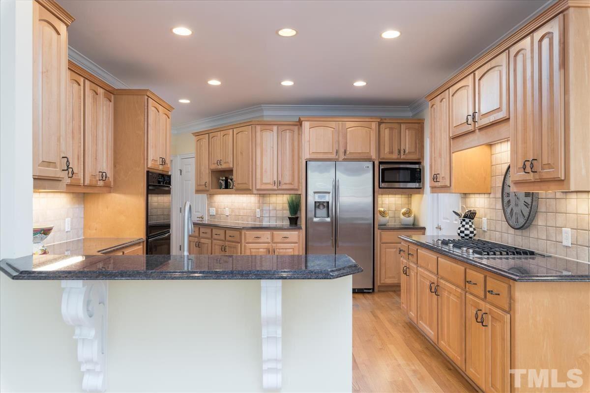 3937 White Chapel Way Raleigh, NC 27614 - Photo 14 of 30 a kitchen with stainless steel appliances granite countertop a stove a sink and a refrigerator