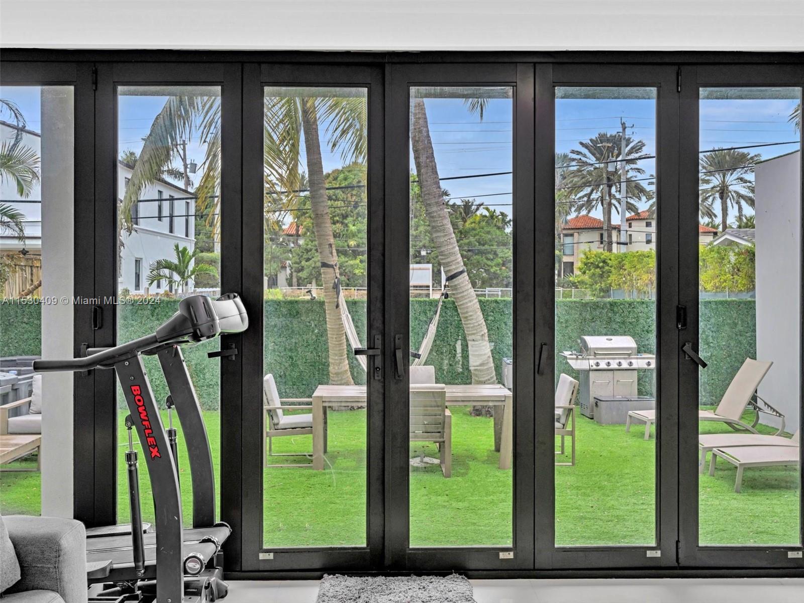 3010 Alton Road Miami Beach, FL 33140 - Photo 14 of 41 a view of a living room and floor to ceiling window