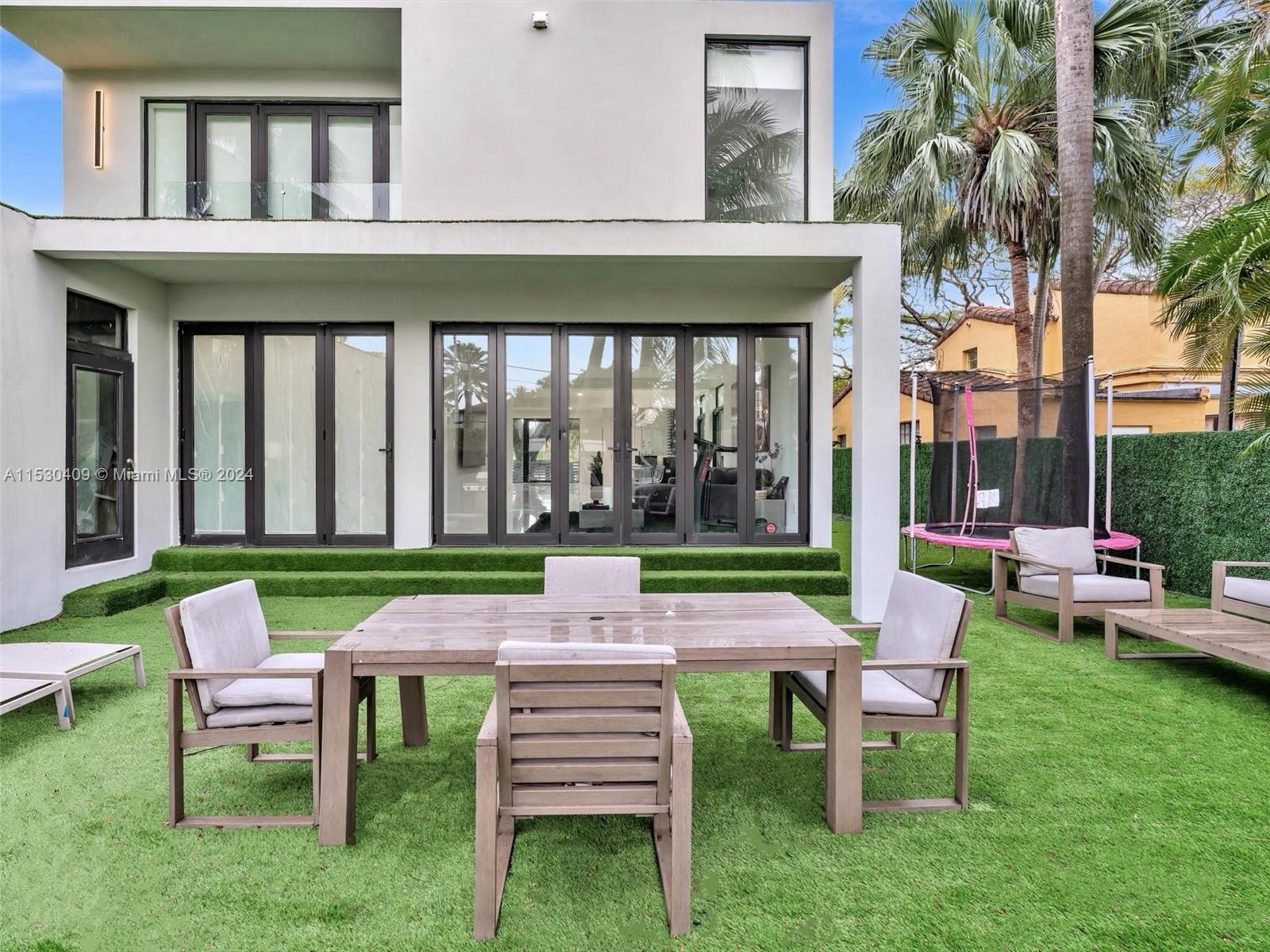 3010 Alton Road Miami Beach, FL 33140 - Photo 16 of 41 a patio that has couches chairs and a big yard