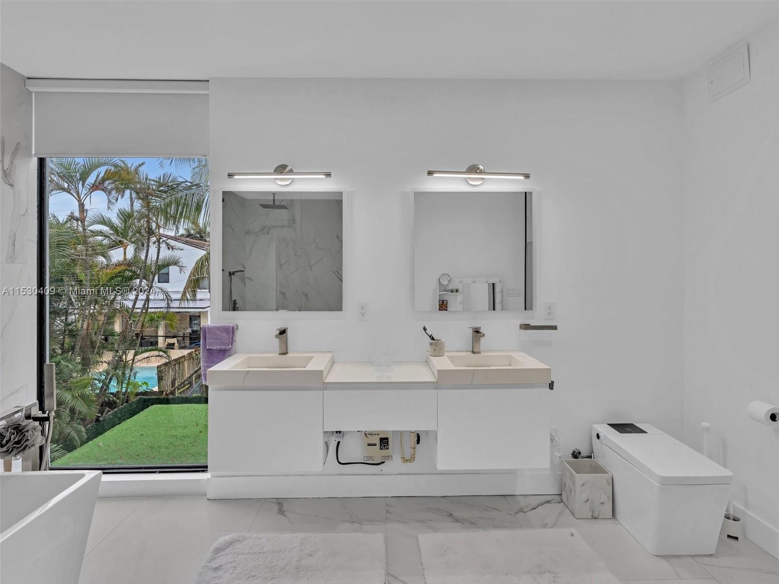 3010 Alton Road Miami Beach, FL 33140 - Photo 26 of 41 a bathroom with a sink and a mirror