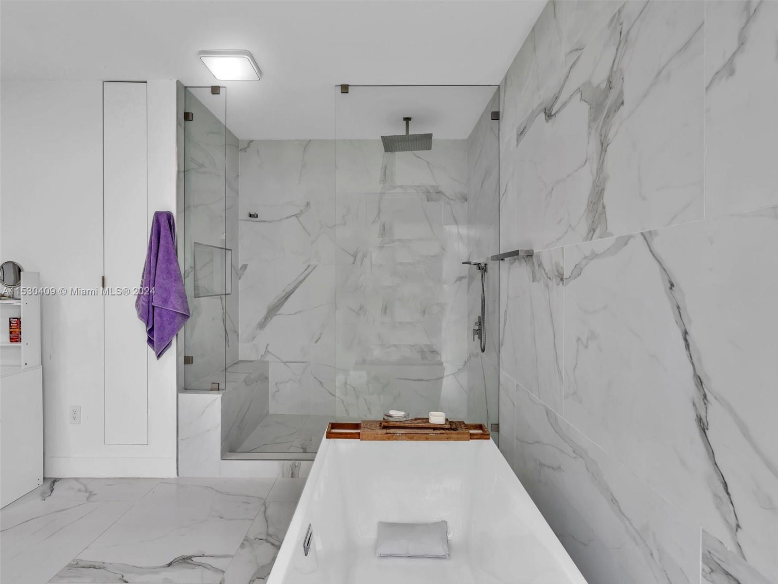 3010 Alton Road Miami Beach, FL 33140 - Photo 27 of 41 a bathroom with a tub shower vanity and a sink